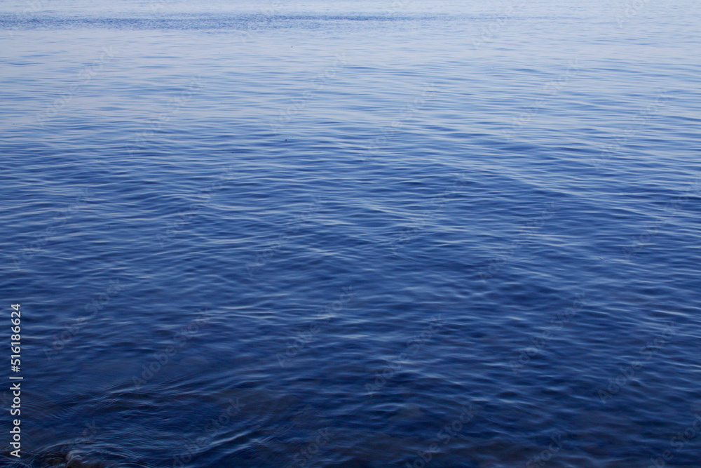Blue sky and sea. The flat surface of a calm sea at dawn. Blue sky and sea. The flat surface of a calm sea at dawn.