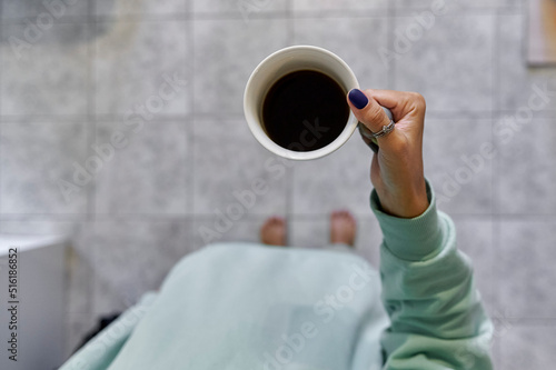 a girl holds a mug of coffee