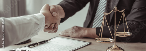 Businessman shaking hands with a lawyer or judge After signing the contract and the agreement is complete, Approval of an agreement between business and law, End of the legal case. photo