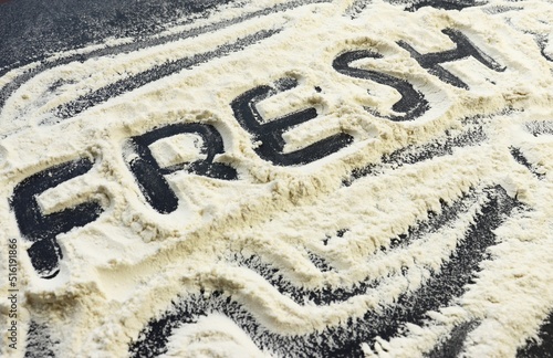 The word fresh on flour on a black background