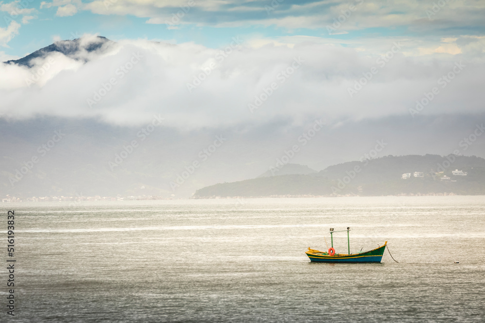Obraz premium Bay with fishermen boat in Jurere beach at sunset Florianopolis, Brazil