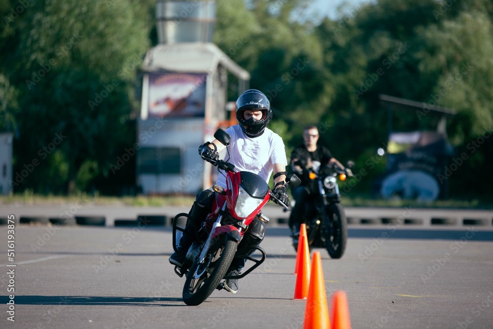 Moto school track driving. A biker on a motorcycle.
Moto school track driving. A biker on a motorcycle.