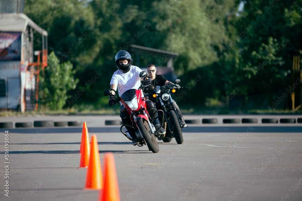 Moto school track driving. A biker on a motorcycle.
Moto school track driving. A biker on a motorcycle.