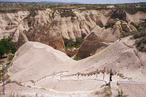 Panoramic top view of beautiful landscape of Cappadocia nature, rocks and hills with stairs, Nevsehir, Turkey.