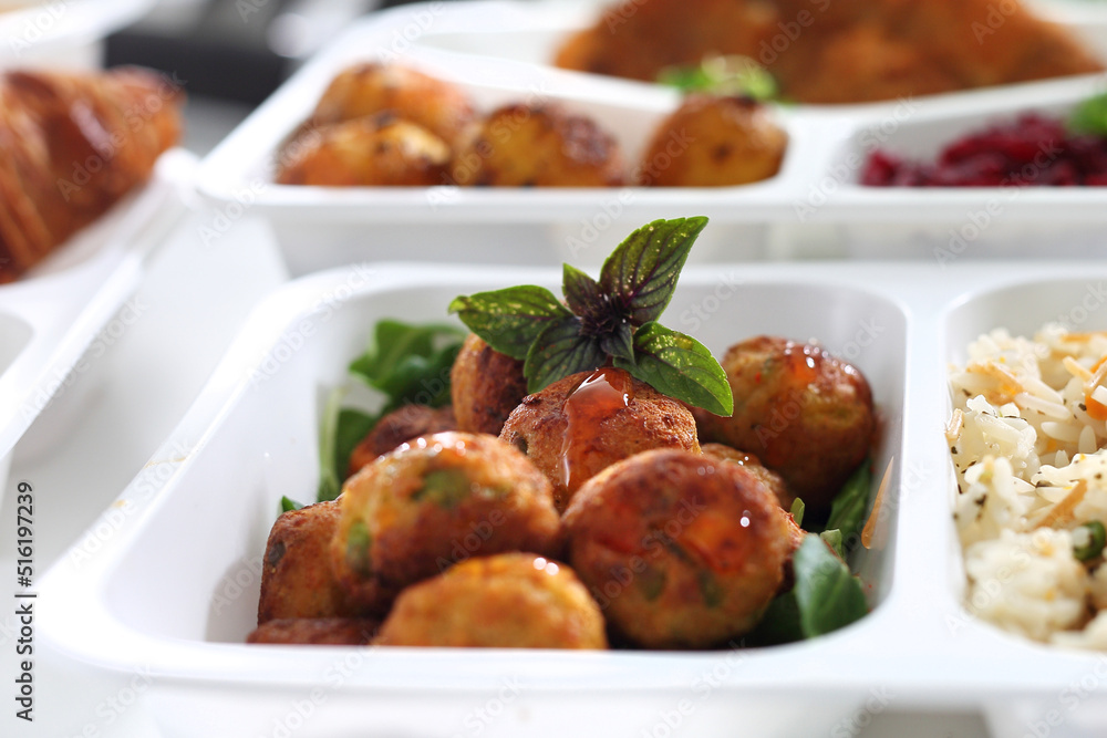 Box diet. vegetable meatballs with rice, and vegetables.Appetizing lunch boxes. Food delivered to your home