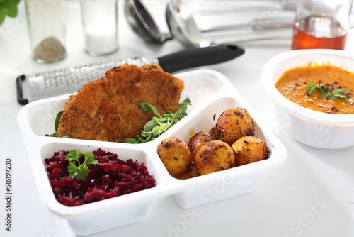 Dietary catering. Veal schnitzel with baked potatoes and beetroot salad. Box diet. Appetizing lunch boxes. Food delivered to your home