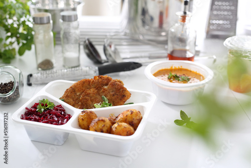 Catering. Veal schnitzel with baked potatoes and beetroot salad. Appetizing lunch boxes. Food delivered to your home