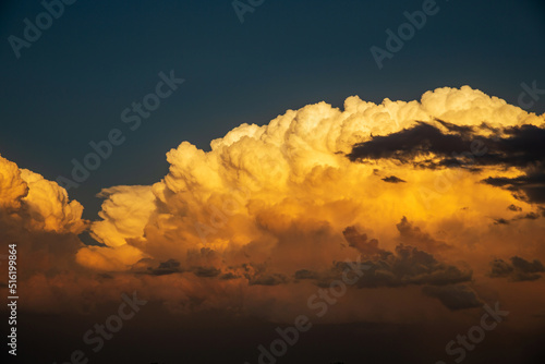 Photos Thunderhead clouds form over the residential area during the summer evening