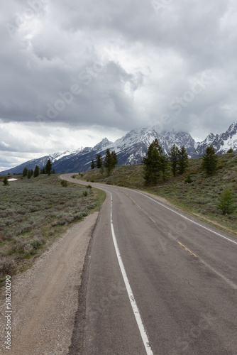 Scenic Road surrounded by Mountains in American Landscape. Spring Season. Grand Teton National Park. Wyoming, United States. Nature Background.