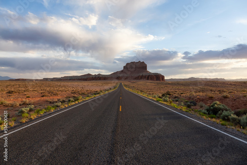 Scenic Road in the Desert with Red Rocky Mountains. Spring Season. Near Goblin Valley State Park. Utah, United States. Adventure Travel.