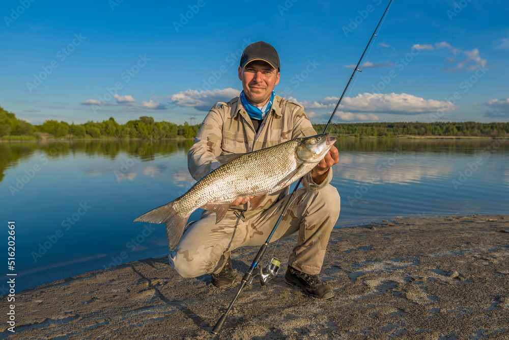Asp fishing. Happy fisherman with big aspius fish Asp fishing. Happy fisherman with big aspius fish