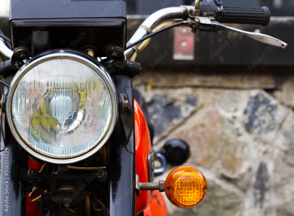 Fototapeta premium Headlight of a standing motorcycle close-up.