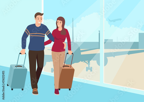 Young couple walking with luggage at the airport