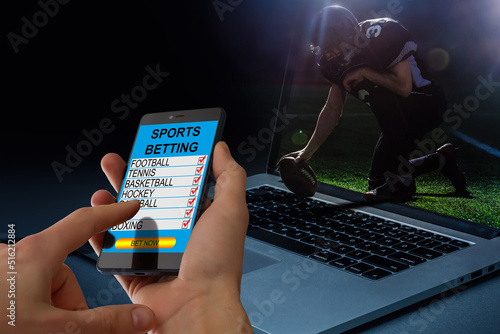 Foto mobile phone and betting during a american football match