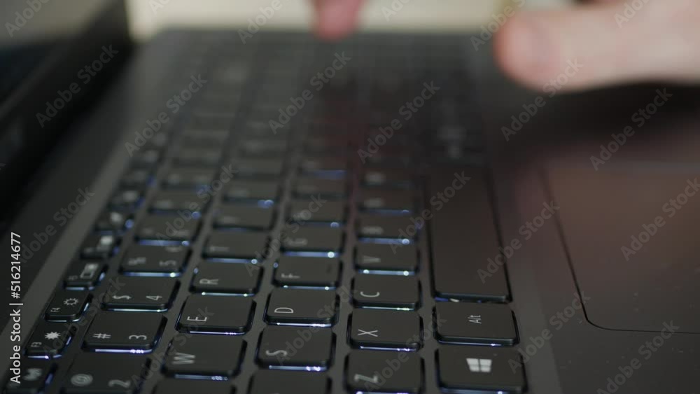 Blurred Shooting with a Man Typing a Text on Laptop Keyboard. Businessman Using a Notebook, Sending Emails, and Browsing Internet. Blurred Shooting with a Man Typing a Text on Laptop Keyboard. Businessman Using a Notebook, Sending Emails, and Browsing Internet.