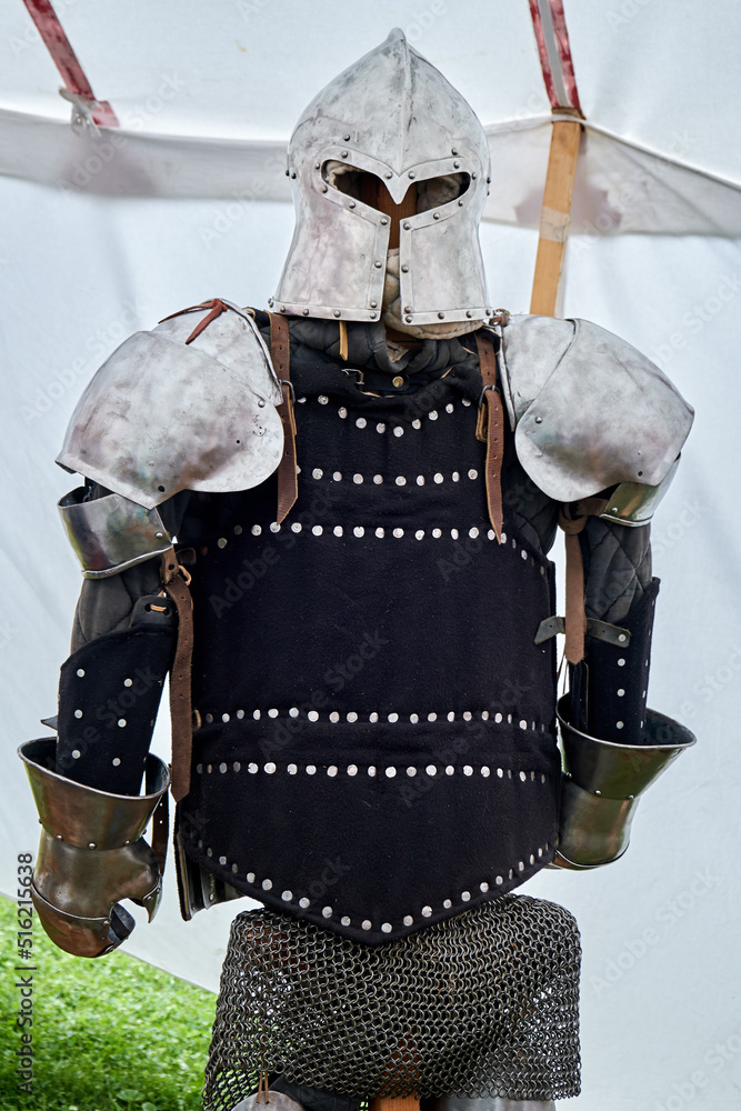 Naklejka premium Medieval vintage armor and retro warrior helmet. Reconstruction of the events of the Middle Ages in Europe.