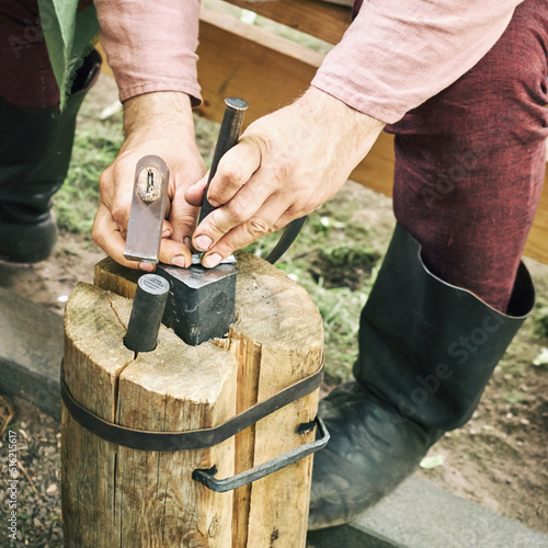 Production of medieval coins by casting and forging. Reconstruction of the events of the Middle Ages in Europe.