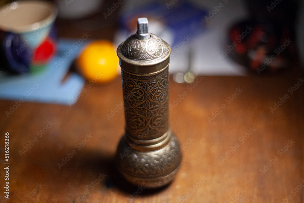 Spice mill. Subject is in oriental style. Thing is on table. Steel product in kitchen. Spice mill. Subject is in oriental style. Thing is on table. Steel product in kitchen.