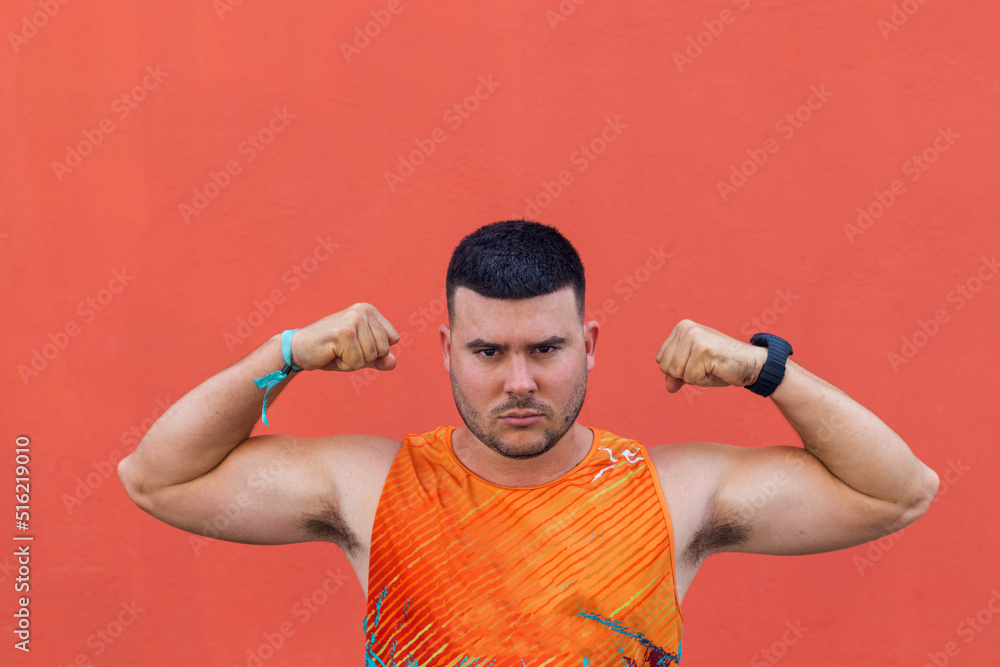 Young sportsman in orange t-shirt and fighting pose. Young sportsman in orange t-shirt and fighting pose.