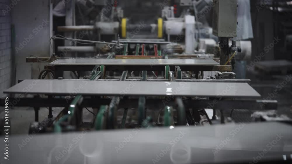 Factory for the production of ceramic tiles and porcelain tiles. Automatic conveyor in the workshop. Factory for the production of ceramic tiles and porcelain tiles. Automatic conveyor in the workshop.