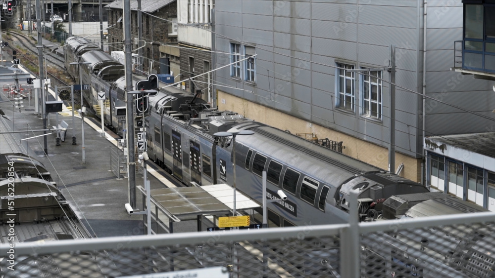 Arriving train in a railway station, Rennes, France. Stock footage. The train coming to the platform of the railroad station, railway infrastructure.