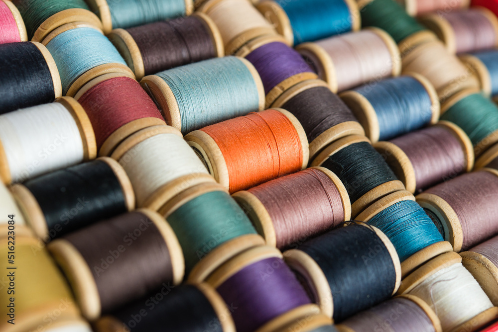 Multi-colored spools of thread close-up. Sewing threads multicolored background closeup Multi-colored spools of thread close-up. Sewing threads multicolored background closeup