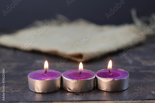 burning candle photo studio gold light of purple candle