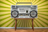Retro ghetto blaster boombox, radio and audio tape recorder on vintage background.
