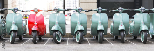 Photos Vintage moped scooter in row on a parking of the city.