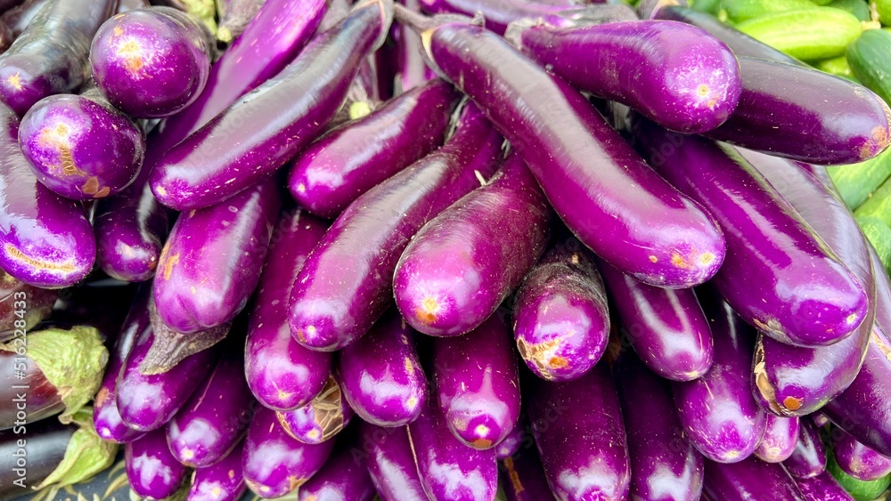 Purple Japanese eggplants in stack at farmers market Purple Japanese eggplants in stack at farmers market