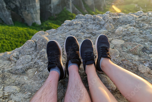 couple feet relaxing in sunny mountains, summer travel together concept. Greece, Meteora rocks. close up