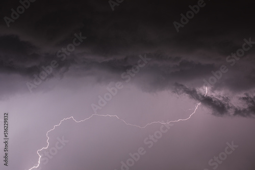 lightning with unusual shape from black storm cloud