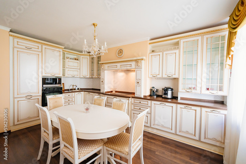 The interior of a large and spacious kitchen-living room in a classic style. 