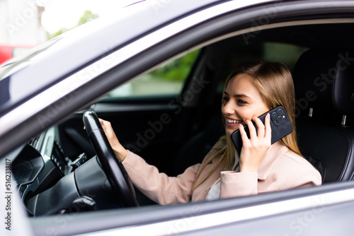 Young businesswoman driving car and talking on cell phone concentrating on the road © F8  \ Suport Ukraine