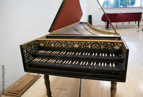 baroque style harpsichord, old renaissance classic piano with black wooden keys photo