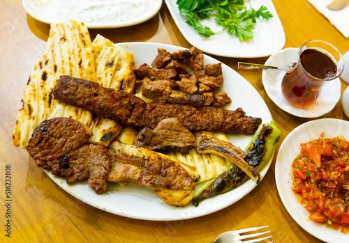 Kirmizi et tabagi. Plate with fried meat, pita bread and stewed peppers. Turkish cuisine photo