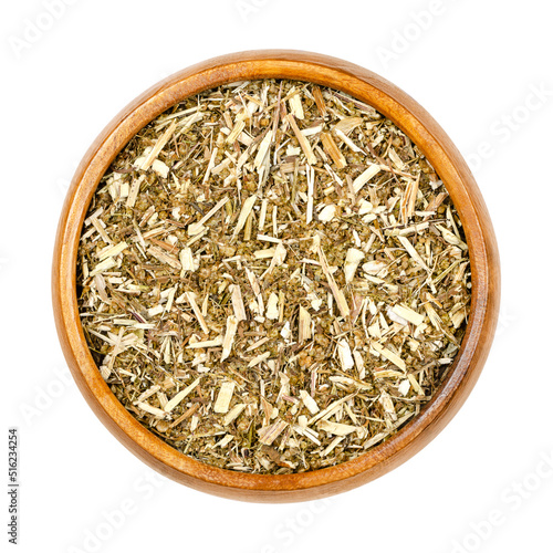 Sweet wormwood, dried herb, Artemisia annua in wooden bowl. The discovery of the plant extract artemisinin is a Nobel prize awarded medication used to treat malaria. Used in TCM as tea to treat fever. photo