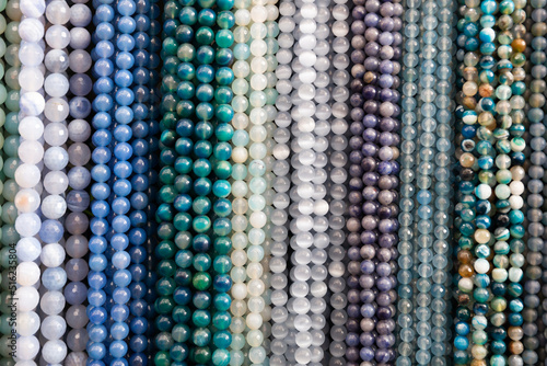 Beads from various semi-precious stones at the stand of a jewelry store