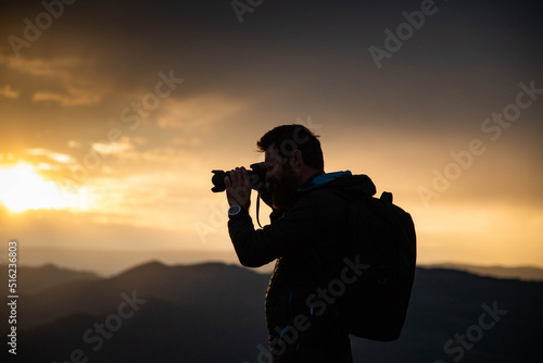 male photographer in nature at sunset