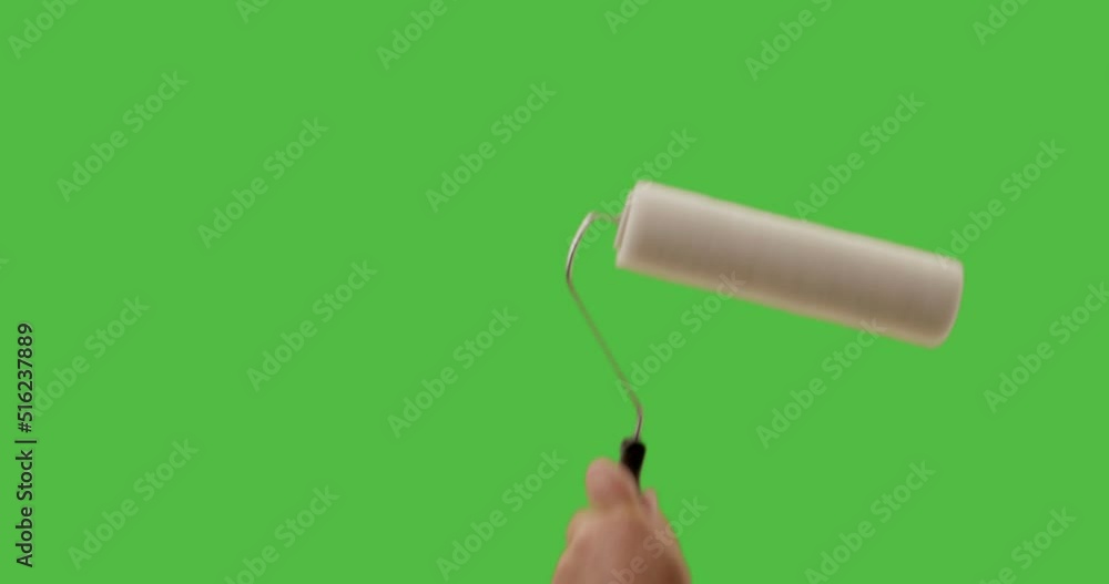 Male Using Paint Roller Two Strokes Across Green Screen. Male Using Paint Roller Two Strokes Across Green Screen.
