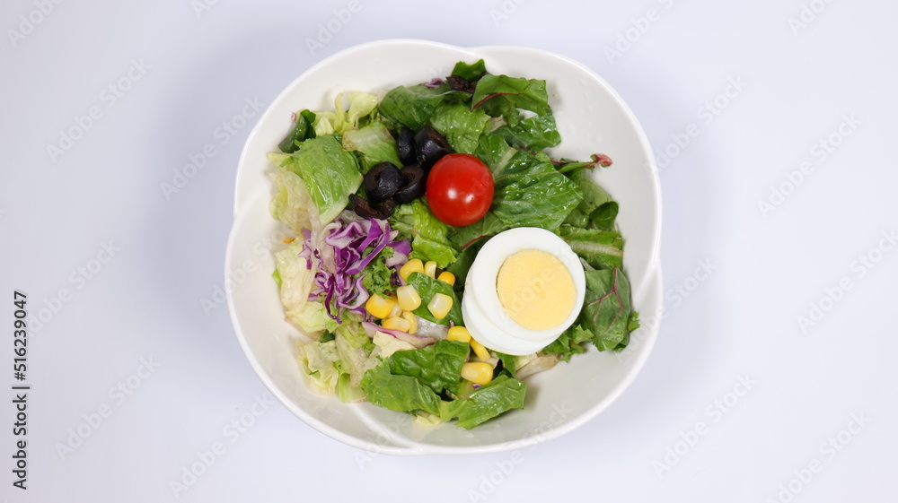 Salad topped with tomatoes and eggs Salad topped with tomatoes and eggs