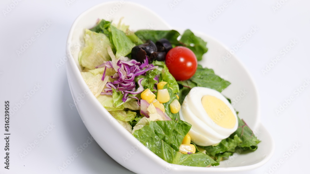 Salad topped with tomatoes and eggs Salad topped with tomatoes and eggs