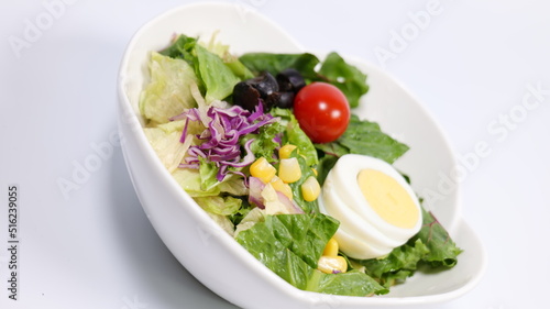 Salad topped with tomatoes and eggs