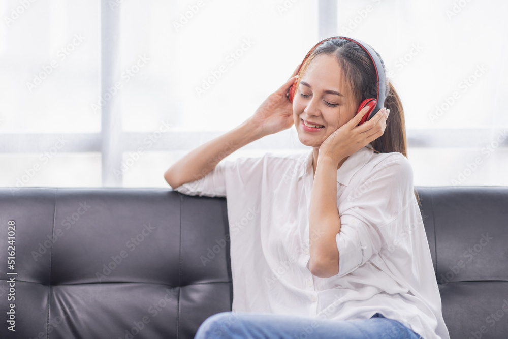 Young beautiful Asian woman girl in casual wear relaxing and listening to music headphones and working indoor Young beautiful Asian woman girl in casual wear relaxing and listening to music headphones and working indoor