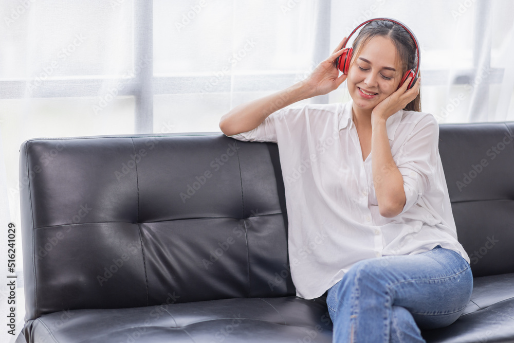 Young beautiful Asian woman girl in casual wear relaxing and listening to music headphones and working indoor Young beautiful Asian woman girl in casual wear relaxing and listening to music headphones and working indoor