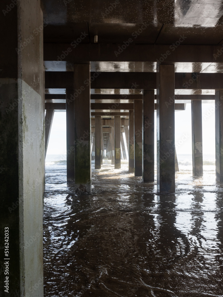 Concrete and Metal Supports on a Fishing Pier with Incoming Water