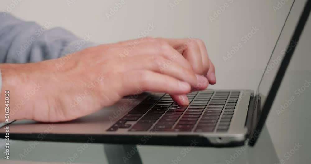 Programmer writes code for website using laptop in office Programmer writes code for website using laptop in office