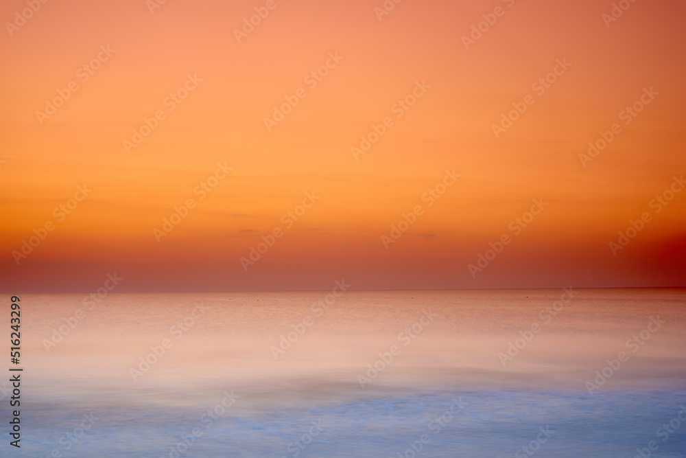 Copy space sunset on the West coast of Jutland, Lokken, Denmark. dramatic sea sunset. A burning sky and shining golden water. Orange sky, yellow sun, and amazing sea. Summer sunset seascape.