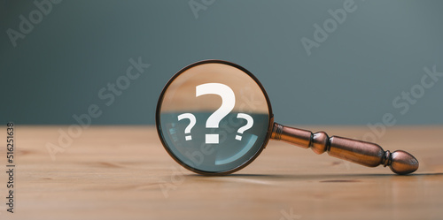 close up magnifier glass with question mark, concept of finding or searching for idea, search for information, find out, Find the answer. photo