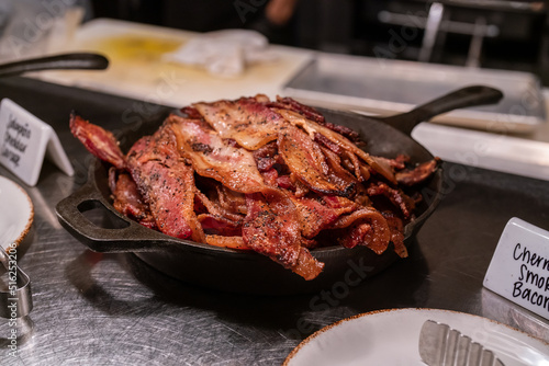 pile of bacon in frying pan